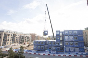The new Concordia Academy modular school is craned into position by McAvoy
